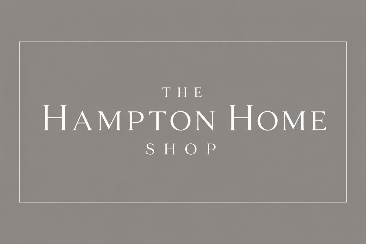 Logo of The Hampton Home Shop on a gray background